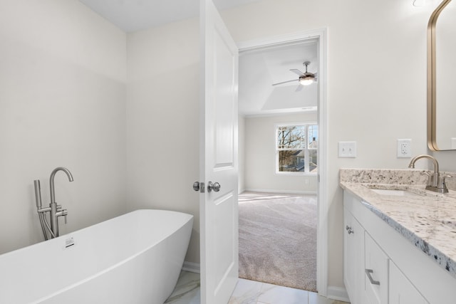 bathroom with ceiling fan, vanity, and a bathing tub