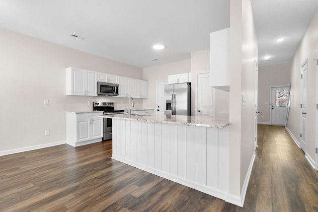 kitchen featuring dark hardwood / wood-style floors, kitchen peninsula, white cabinetry, stainless steel appliances, and light stone counters