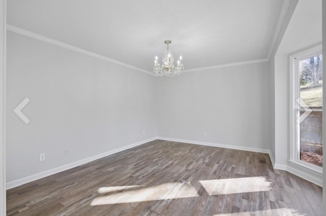 unfurnished room featuring hardwood / wood-style floors, a chandelier, and crown molding