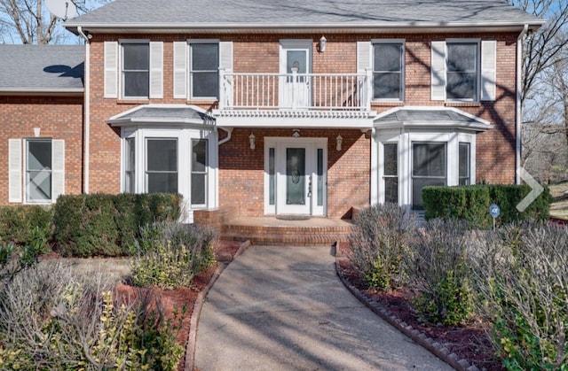 view of front of home featuring a balcony