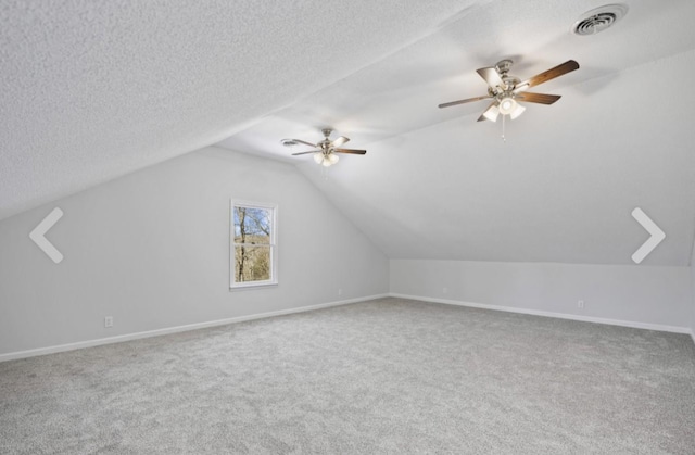 bonus room with ceiling fan, vaulted ceiling, a textured ceiling, and carpet flooring