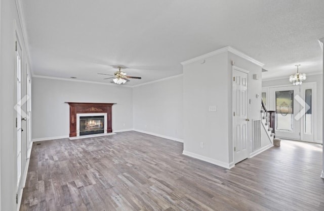 unfurnished living room featuring hardwood / wood-style floors, crown molding, and ceiling fan with notable chandelier