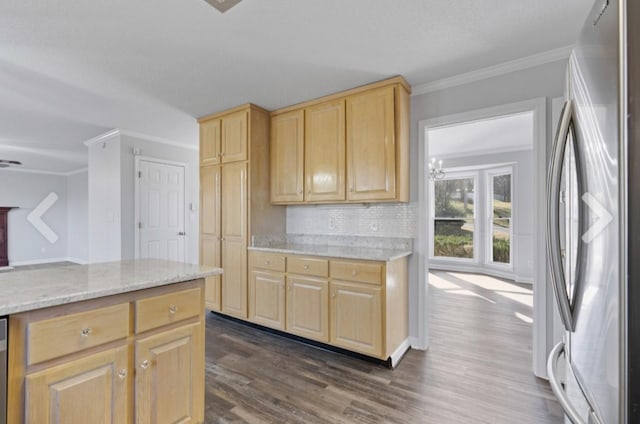 kitchen with light stone countertops, light brown cabinetry, ornamental molding, and stainless steel fridge