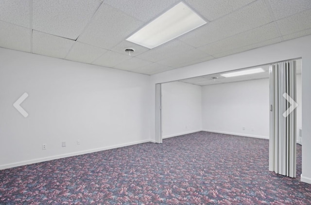 basement with carpet flooring and a drop ceiling