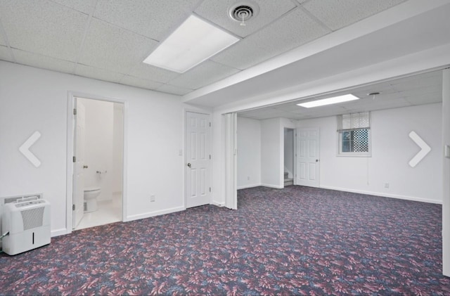 basement featuring carpet floors and a drop ceiling