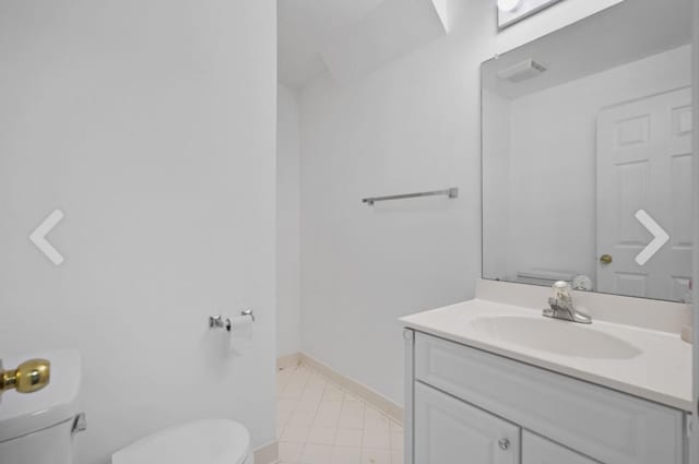 bathroom featuring toilet and vanity