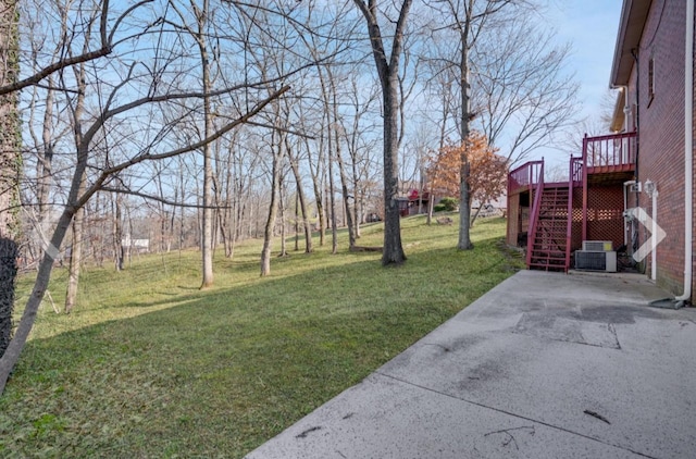 view of yard featuring central AC and a wooden deck