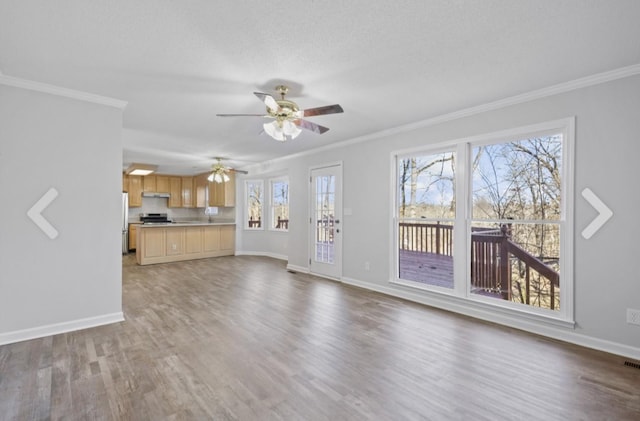 unfurnished living room with ceiling fan, hardwood / wood-style flooring, and crown molding