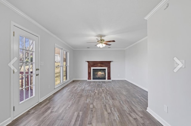 unfurnished living room with ornamental molding, ceiling fan, and wood-type flooring