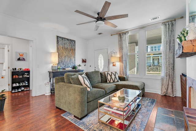 living room featuring dark hardwood / wood-style flooring and ceiling fan