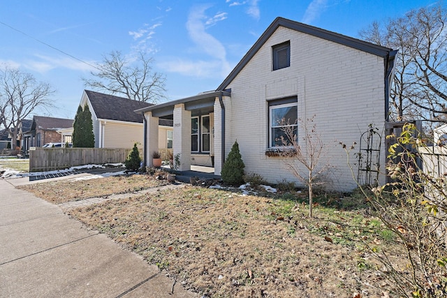 view of side of property featuring covered porch