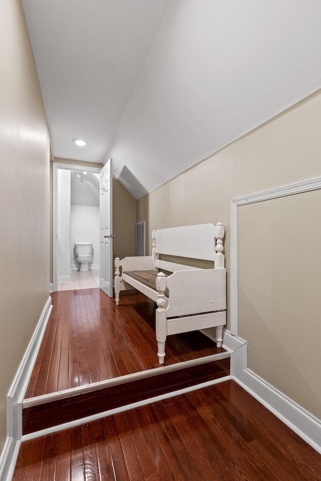 bedroom featuring lofted ceiling and hardwood / wood-style flooring