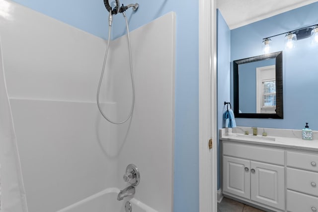 bathroom featuring tile patterned flooring, vanity, a textured ceiling, and shower / bath combination