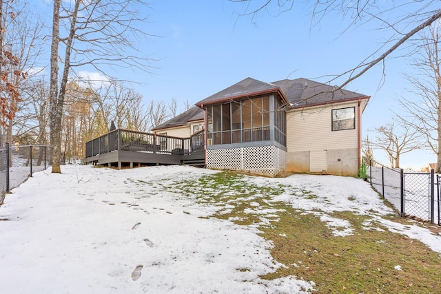 view of front of home with a wooden deck and a sunroom