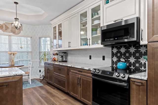 kitchen featuring light stone counters, electric stove, a raised ceiling, white cabinetry, and wood-type flooring