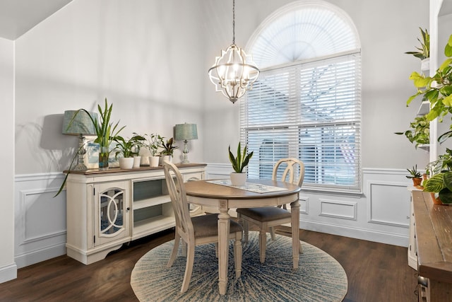 dining room with dark wood-type flooring and a chandelier