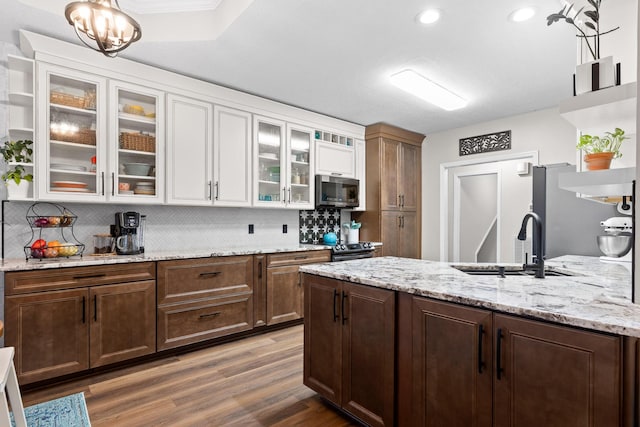 kitchen with sink, white cabinets, decorative backsplash, dark hardwood / wood-style floors, and appliances with stainless steel finishes