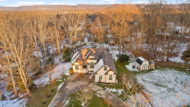 snowy aerial view with a mountain view