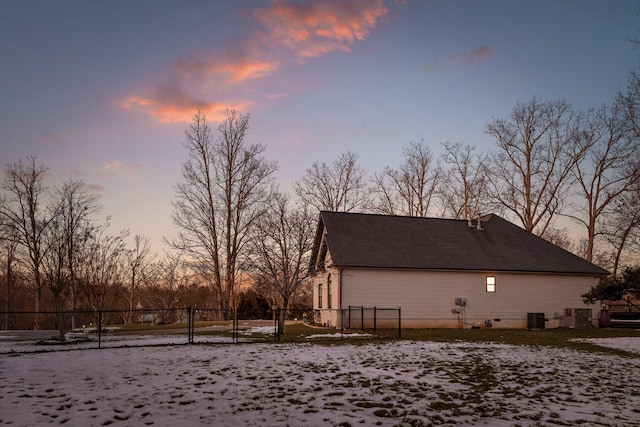 property exterior at dusk featuring central AC unit