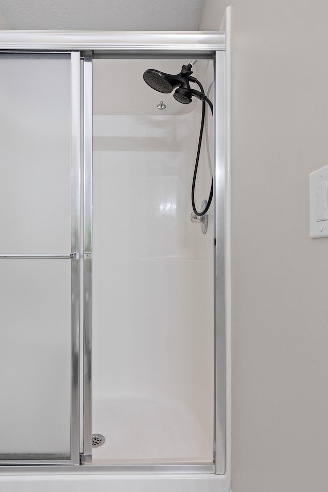 bathroom with a shower with shower door