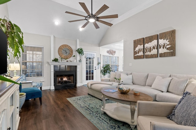 living room with dark hardwood / wood-style floors, ornamental molding, lofted ceiling, a fireplace, and ceiling fan