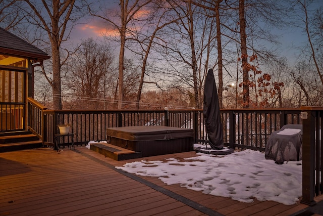 snow covered deck with a hot tub