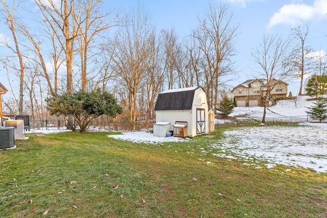 snowy yard featuring a shed