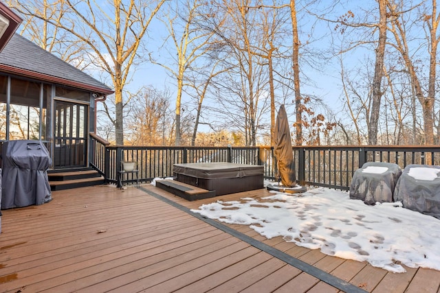 snow covered deck featuring a sunroom, grilling area, and a hot tub