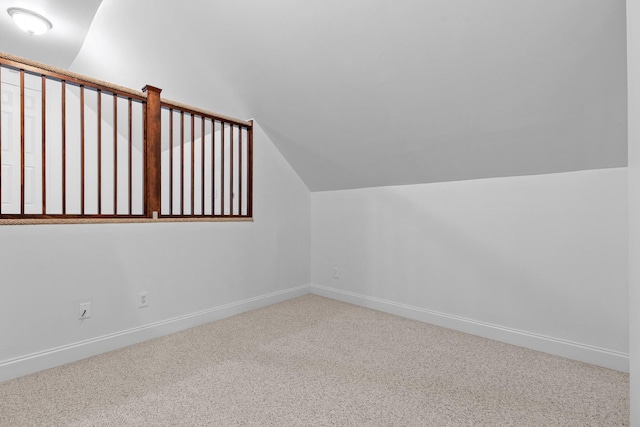 bonus room with carpet floors and vaulted ceiling