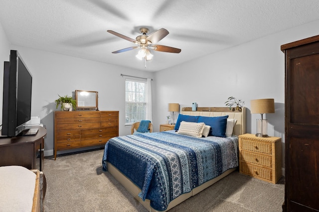 carpeted bedroom with a textured ceiling and ceiling fan