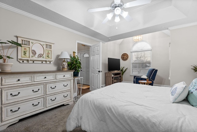 carpeted bedroom with ceiling fan and a tray ceiling