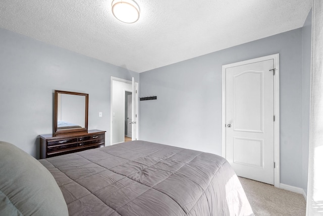 carpeted bedroom featuring a textured ceiling