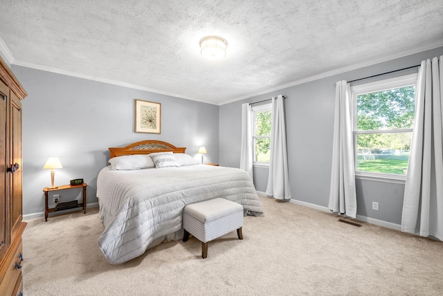 carpeted bedroom with ornamental molding and a textured ceiling