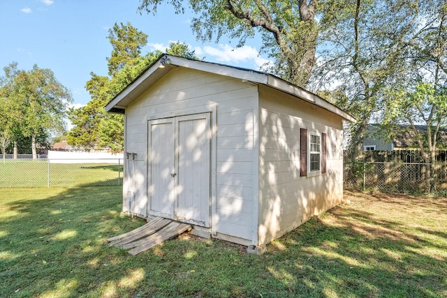 view of outbuilding with a yard