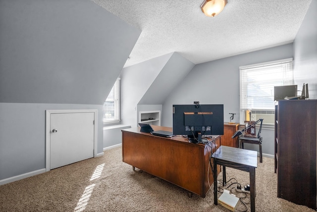 office area with a textured ceiling, vaulted ceiling, and carpet flooring