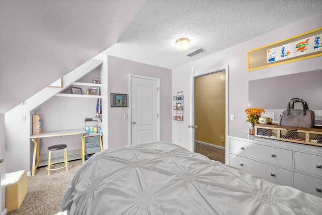 bedroom with a textured ceiling and carpet flooring