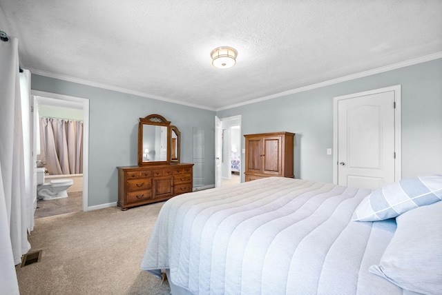 bedroom featuring ensuite bathroom, light colored carpet, and crown molding