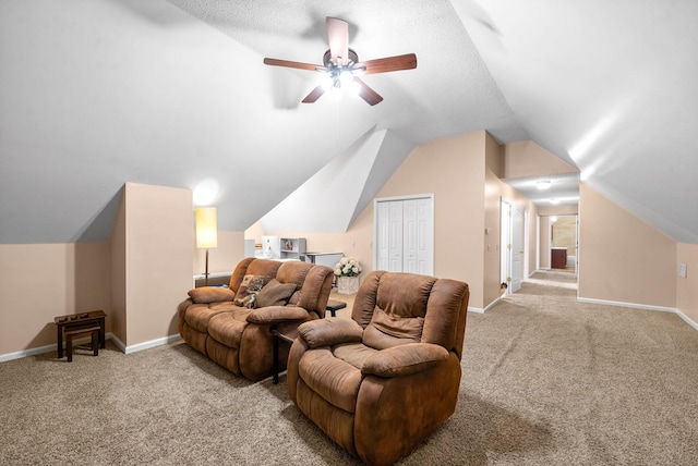 home theater featuring lofted ceiling, a textured ceiling, ceiling fan, and light colored carpet