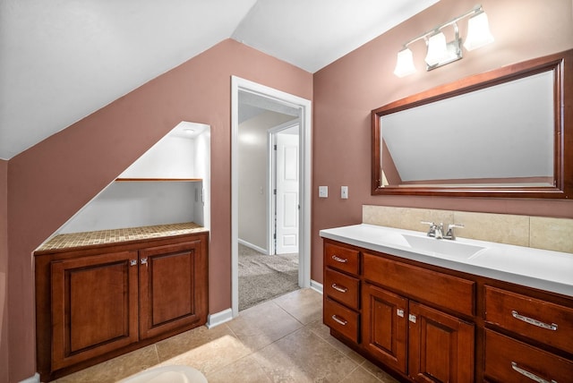 bathroom with vaulted ceiling and vanity