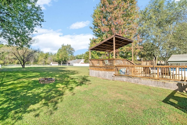 view of yard with a fire pit and a wooden deck