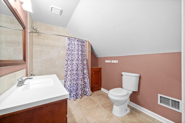 bathroom featuring a shower with shower curtain, vaulted ceiling, vanity, and toilet