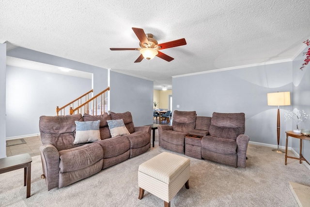 carpeted living room with a textured ceiling, ceiling fan, and crown molding