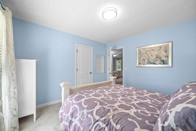 carpeted bedroom featuring a textured ceiling