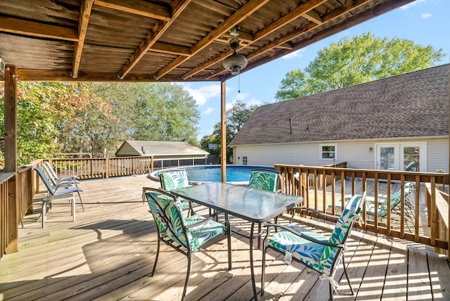 wooden deck featuring a fenced in pool