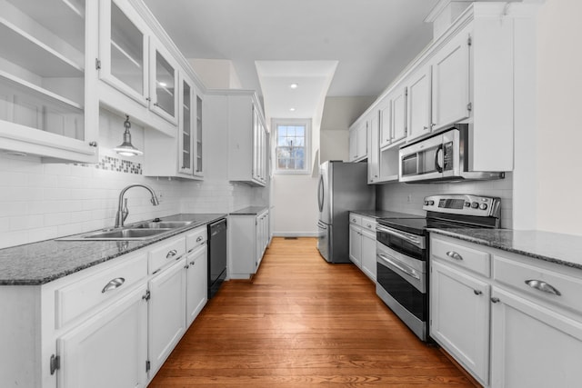 kitchen featuring white cabinetry, appliances with stainless steel finishes, sink, and light hardwood / wood-style flooring