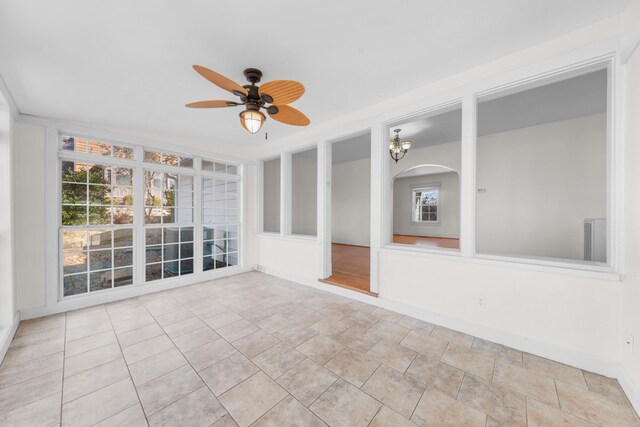 unfurnished sunroom with ceiling fan