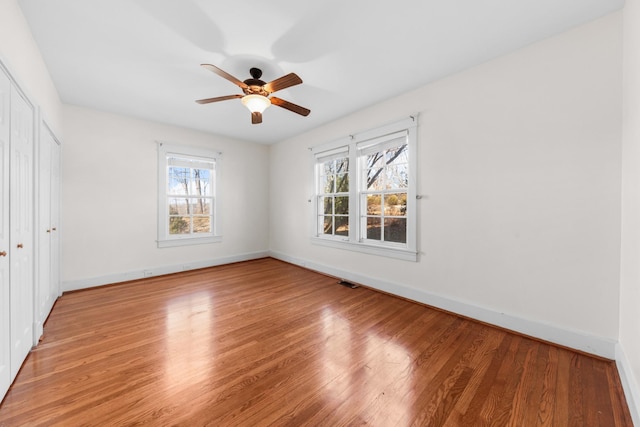 empty room featuring hardwood / wood-style flooring and ceiling fan