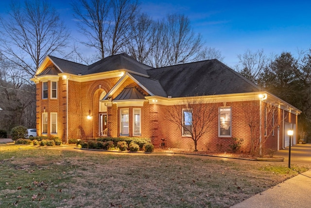 view of front of house featuring a garage and a lawn