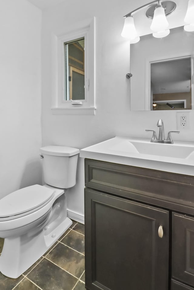 bathroom with vanity, tile patterned floors, and toilet