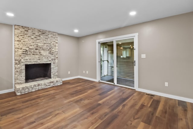 unfurnished living room with wood-type flooring and a fireplace